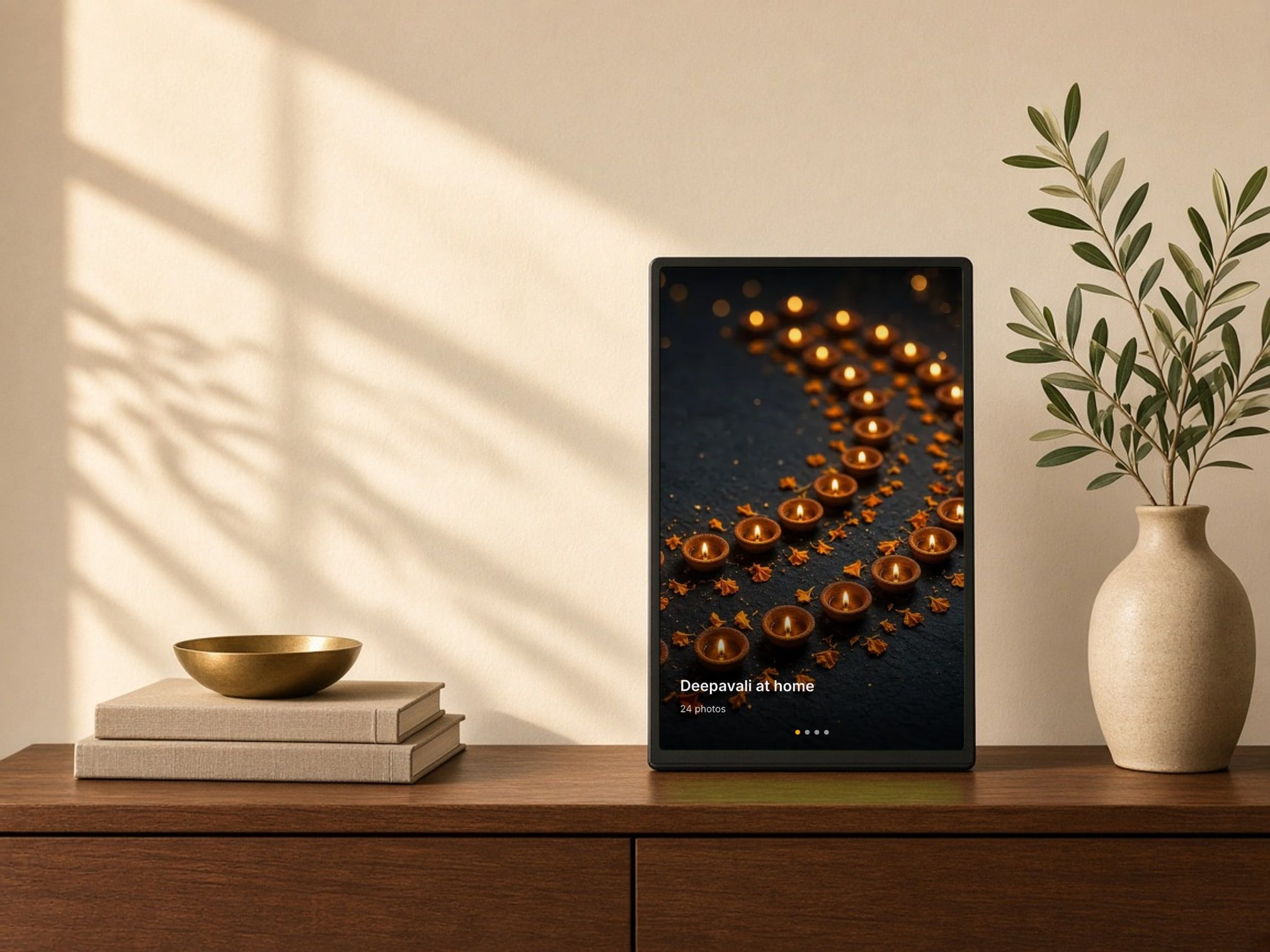 A ThiraiOne display in a wooden frame on a sideboard, showing a festival photo slideshow.